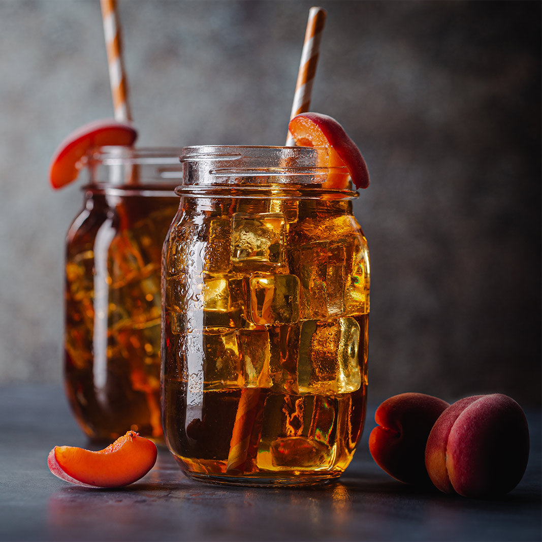 Peach barley tea over ice in glass also known as Ryokucha​